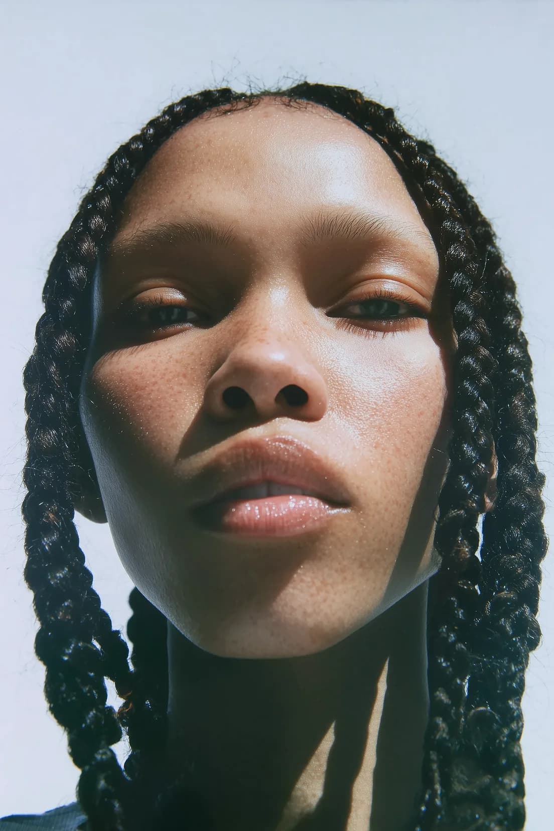 Photorealistic portrait of a Black woman with braided hair